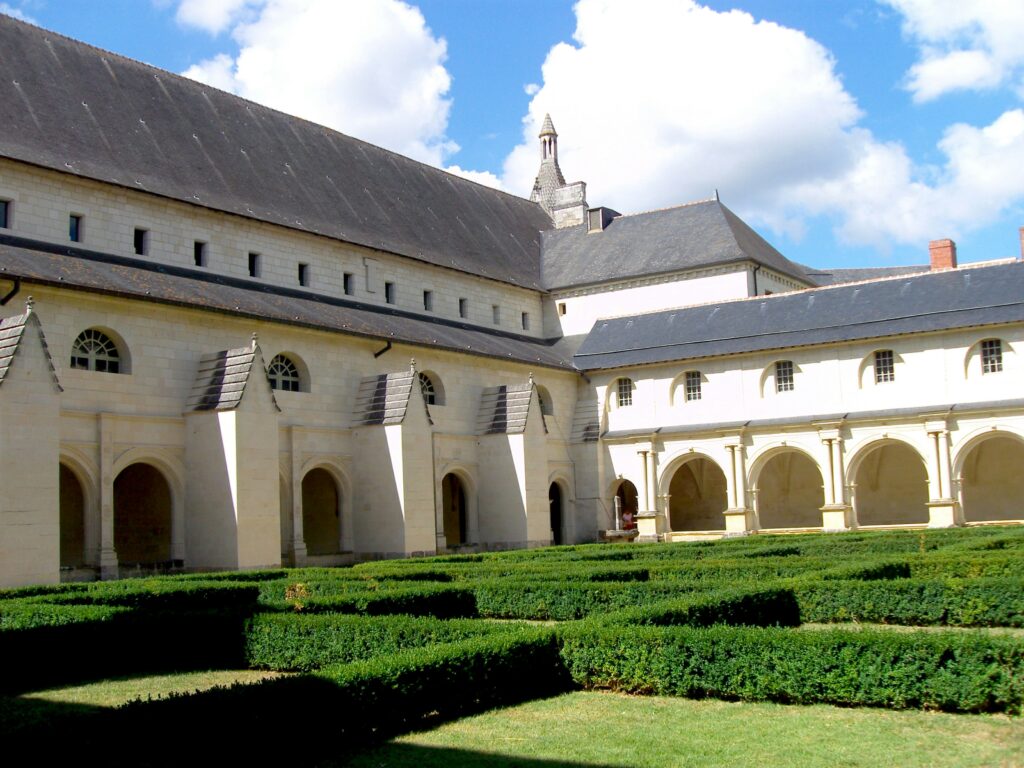 Cour intérieure de l’Abbaye royale de Fontevraud avec jardin et arcades.
